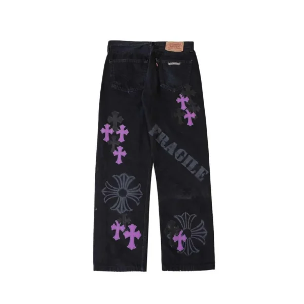 Chrome Hearts black denim jeans with purple cross patches and spray print, back view