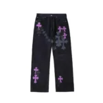 Chrome Hearts black denim jeans with purple cross patches and spray print, front view