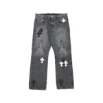 Chrome Hearts grey washed denim jeans with black and white leather cross patches, front view